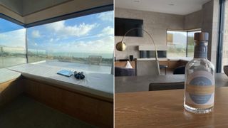 A composite image of a view from the clifftops lodges out to see with a pair of binoculars resting on a padded bench seat and a bottle of gin on a wooden work surface with a contemporary apartment living room in the background.