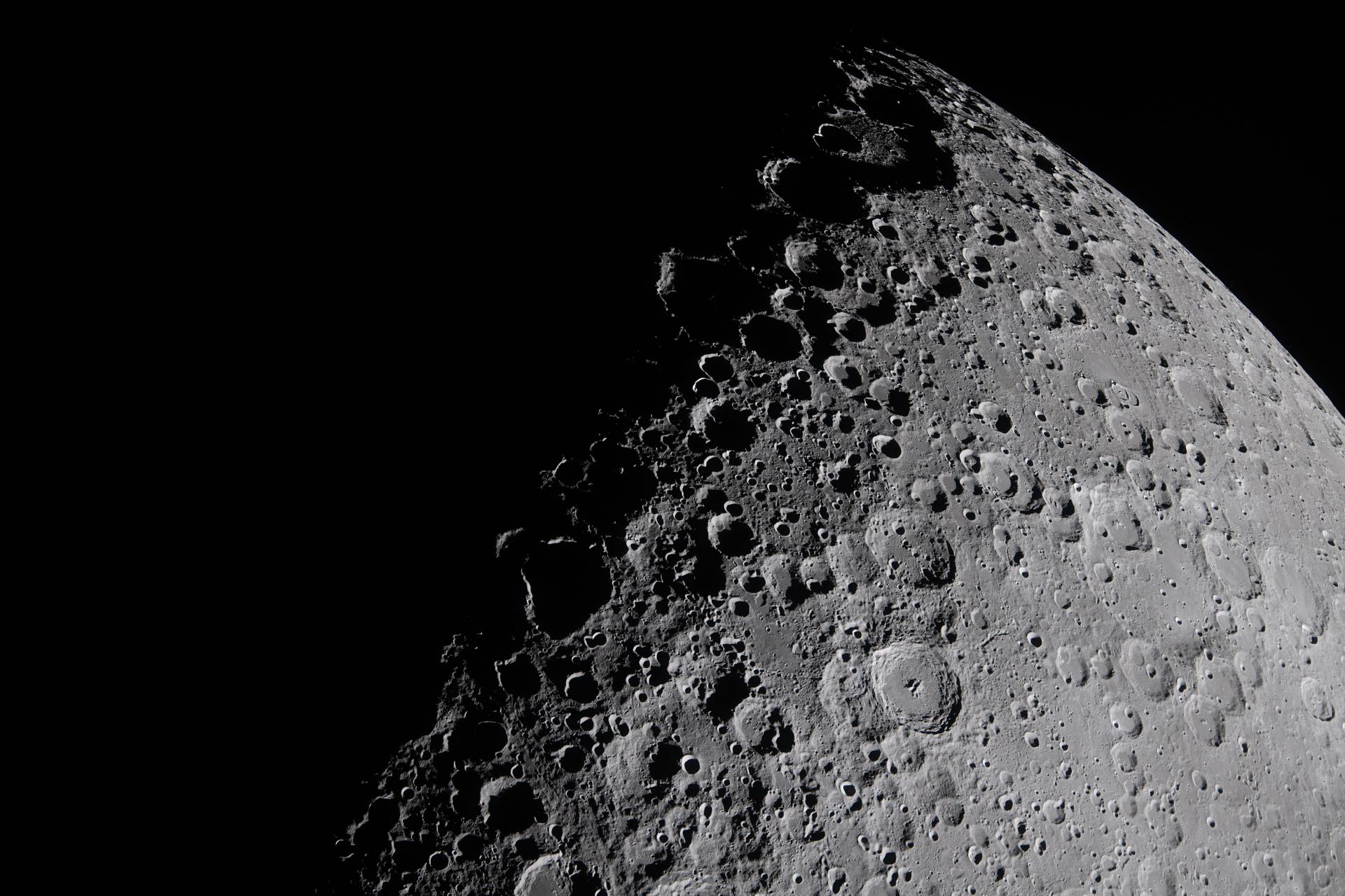 A portion of the Moon coming into view along the terminator &amp;ndash; the boundary between lunar day and night &amp;ndash; where low-angle sunlight casts long, dramatic shadows across the surface.