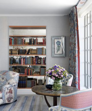 Pale blue living room with wall of shelving