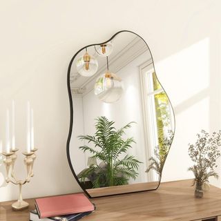 A wavy mirror on a console table