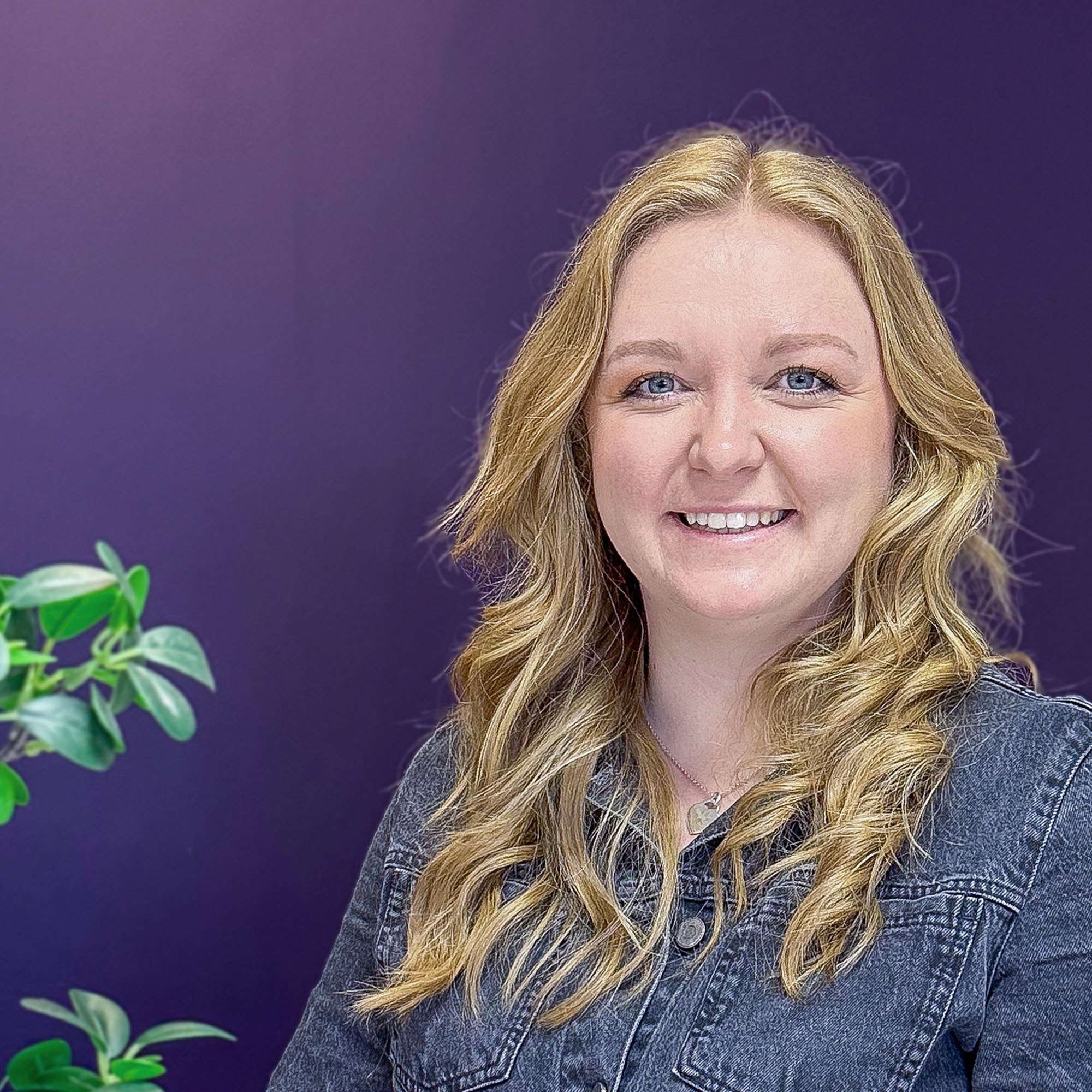 A woman with long blonde hair in front of a purple background - Hannah Shore Head of Sleep Science at Mattress Online