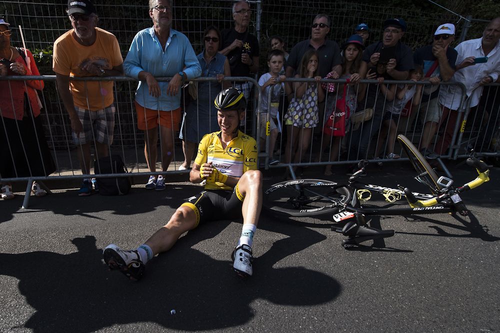Tony Martin rests against the barriers near the finish of stage 6.