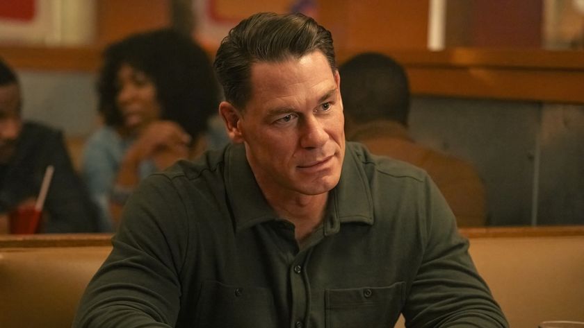 John Cena sitting in restaurant booth in Peacemaker Season 2