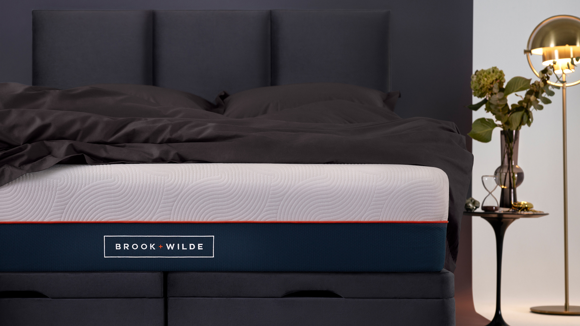 The Brook and Wilde The Lux mattress placed on a black ottoman bed with storage