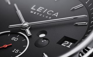 Close-up of black dial of Leica watch with date window
