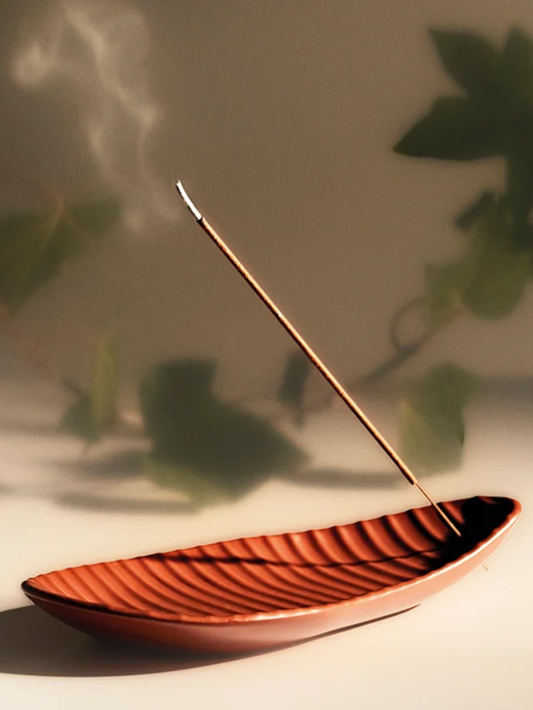 A textured red incense holder from Loewe