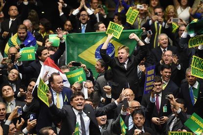 Brazilian lawmakers celebrate having enough votes to proceed with Dilma Rousseff's impeachment.