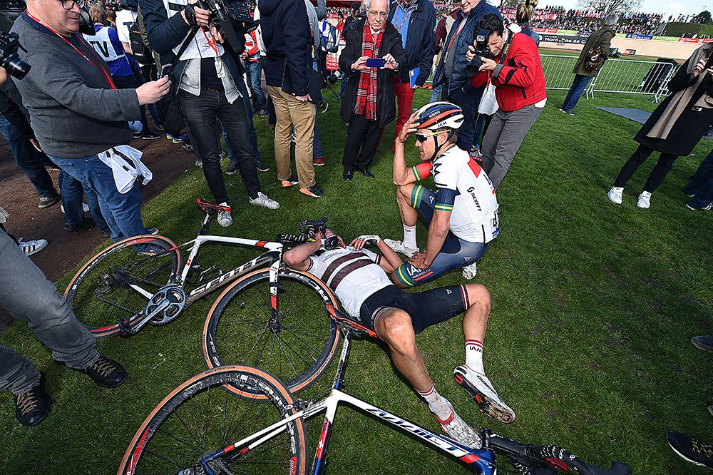 Aleksejs Saramotins lays on the ground as Heinrich Haussler wonderes what might have been after the duo both finished in the top ten