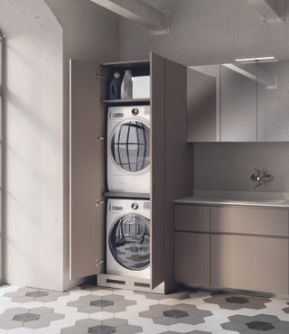 A streamlined utility room idea with stacked laundry machines.