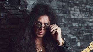 Yngwie Malmsteen looking over his sunglasses