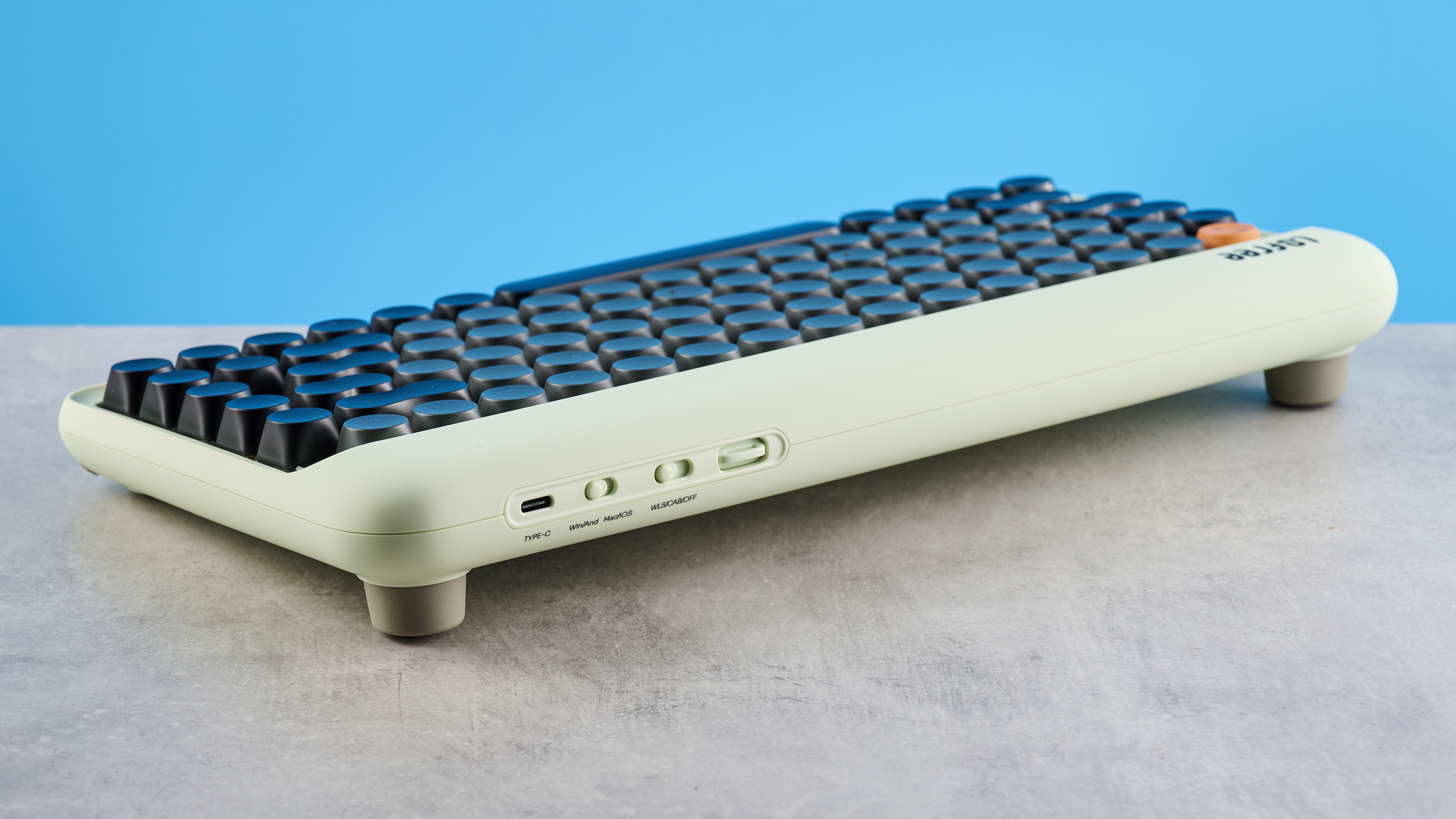 The Lofree DOT on a stone surface showing the rear of its case