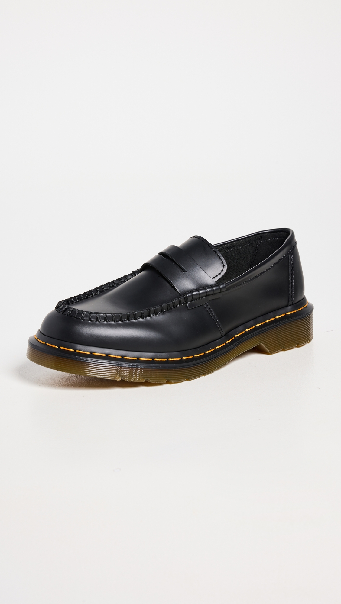 black leather loafers with brown soles