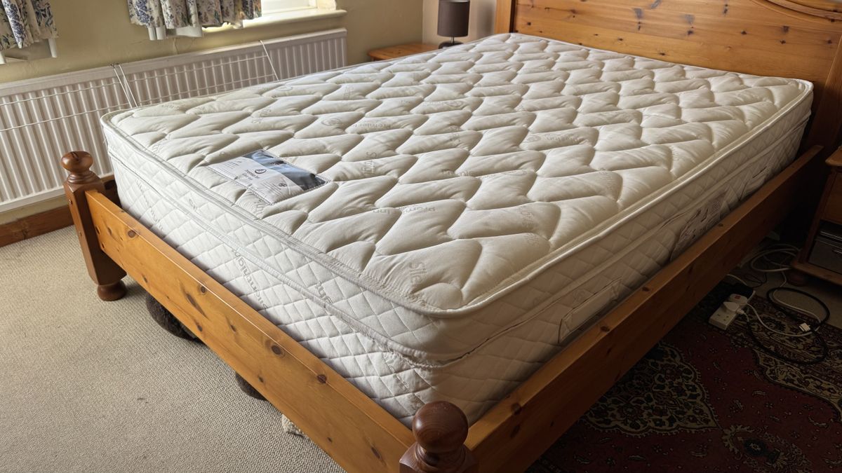 An image of the Premier Inn mattress on a pine bed frame
