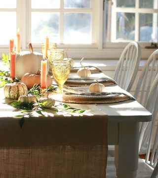 Country dining table with burlap runner and pumpkin table decor