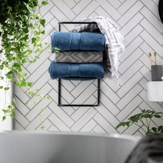 Habitat Wall Mountable Towel Holder with blue towels on white and black tiled wall
