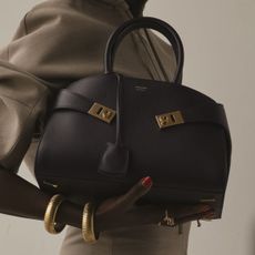 Woman carries ferragamo hug bag