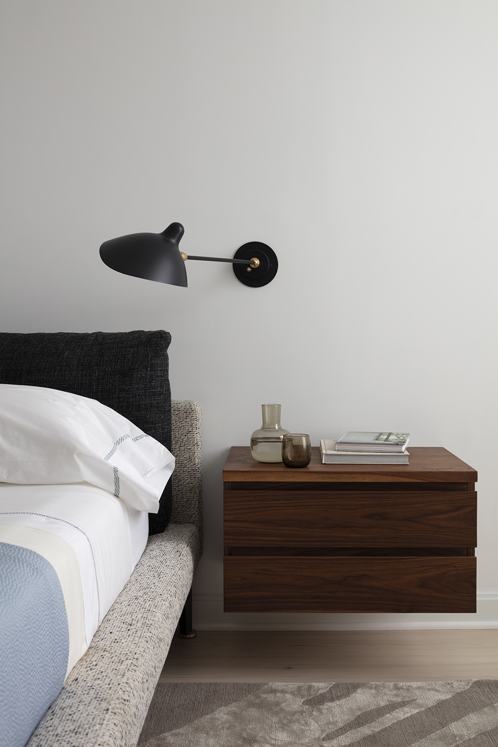 neutral bedroom with blue blanket on the bed