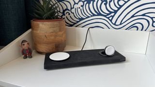 Belkin Boost Charge Pro 3-in-1 Wireless Charging Pad on a bedside table.