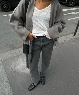 woman wearing grey jeans sweater and loafers