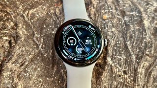 A close-up front view of the Google Pixel Watch 3 and a data-rich watch face