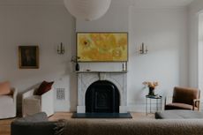 A tv placed above the fireplace