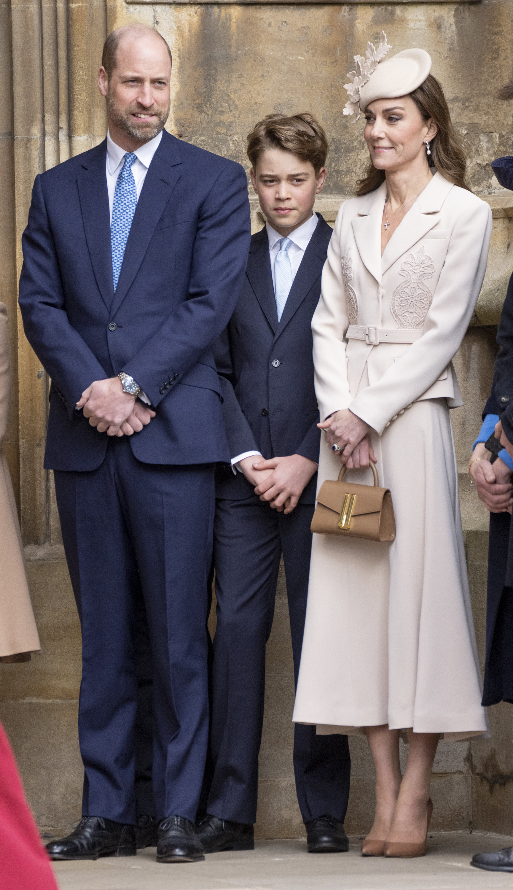Prince William and Prince George wear deep navy suits with blue ties, while Princess Kate, the Princess of Wales, wears a cream Self-Portrait dress and matching hat to attend the 2026 Easter Matins Service at St George's Chapel on April 5, 2026