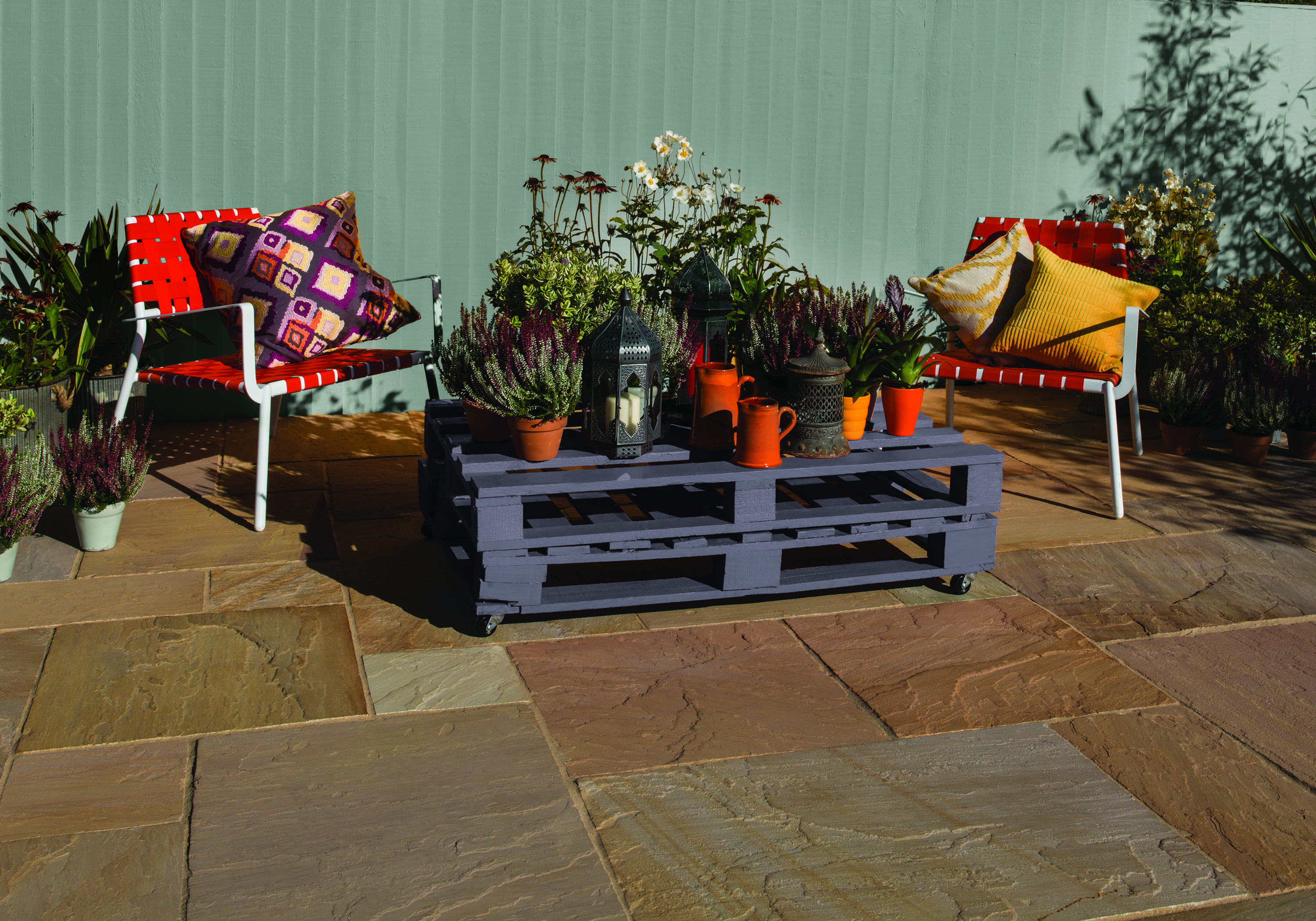modern paving ideas: bradstone tiles and pallet table