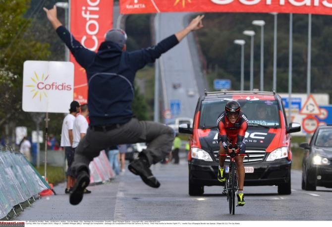 A fan jumps for joy while Philippe Gilbert (BMC) cracks a smile