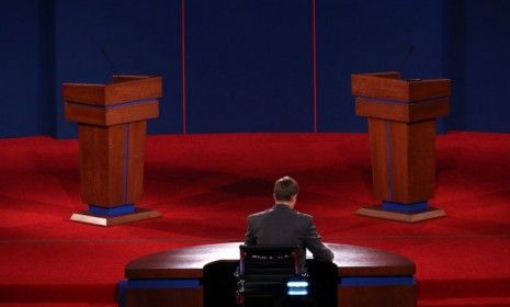 University of Denver student Sam Garry sits at the moderator&amp;#039;s desk before a presidential debate dress rehearsal on Oct. 2: The debate will air tonight on all the major networks, and is avail