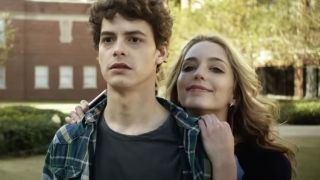 Jessica Rothe leaning on Israel Broussard's shoulders in Happy Death Day