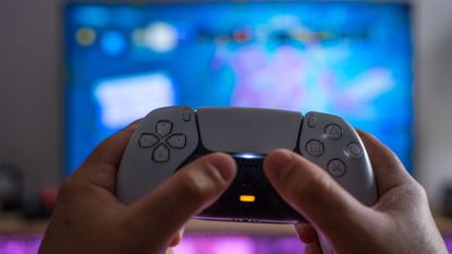 A Ps5 controller in front of a screen