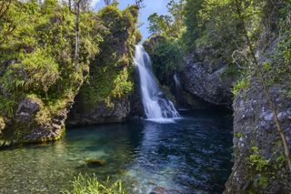 Water from the Hanawi Falls cascades down on the island of Maui