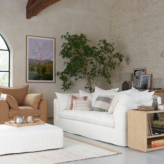 Living room with cream sofa and taupe armchair