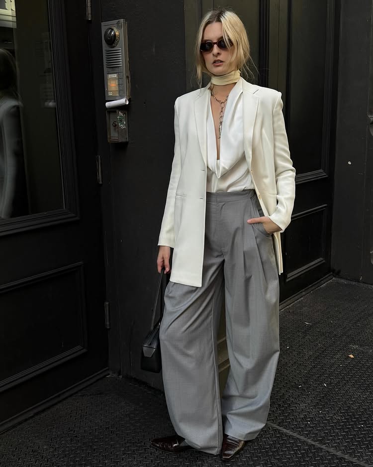 Classic Pieces 2025: @christietyler wears a pair of grey wide-leg trousers with a cream blouse and cream blazer