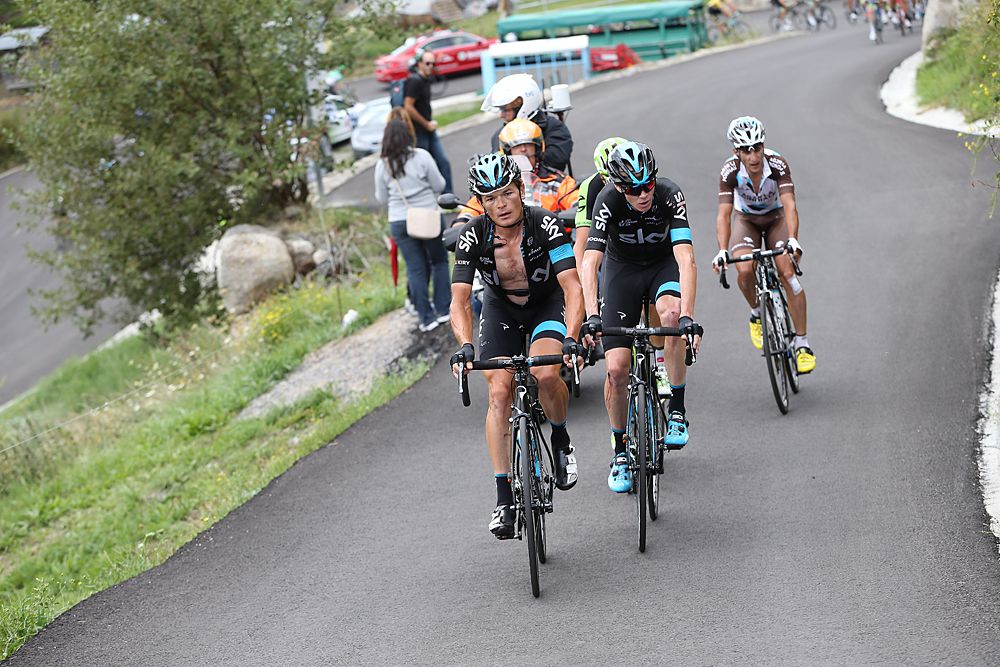 Vasil Kiryienka helps his Sky teammate Chris Froome chase back on after an early crash