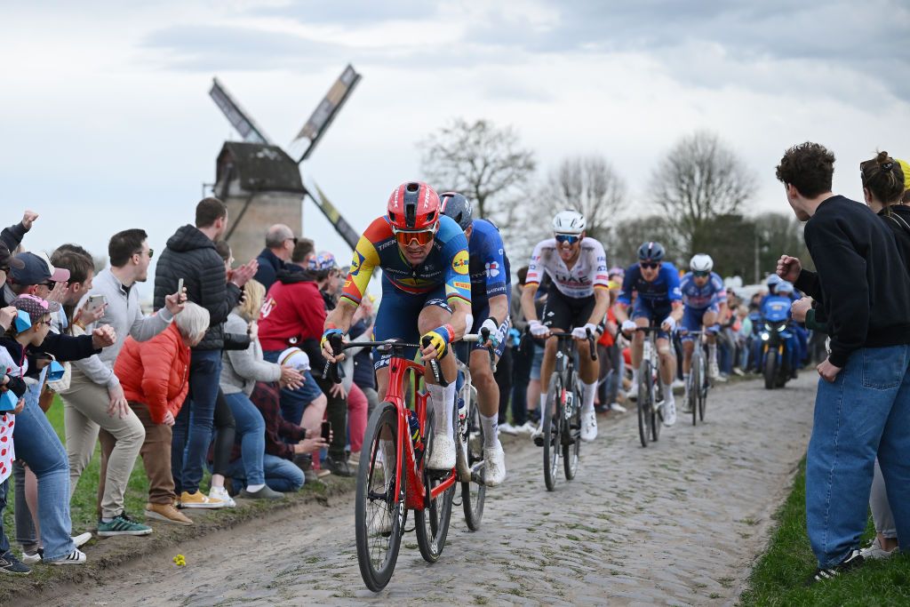 ROUBAIX FRANCE APRIL 07 Mads Pedersen of Denmark and Team Lidl Trek competes in the chase group passing through the Templeuve MoulindeVertain cobblestones sector while fans cheer during the 121st ParisRoubaix 2024 a 2597km one day race from Compiegne to Roubaix UCIWT on April 07 2024 in Roubaix France Photo by Dario BelingheriGetty Images