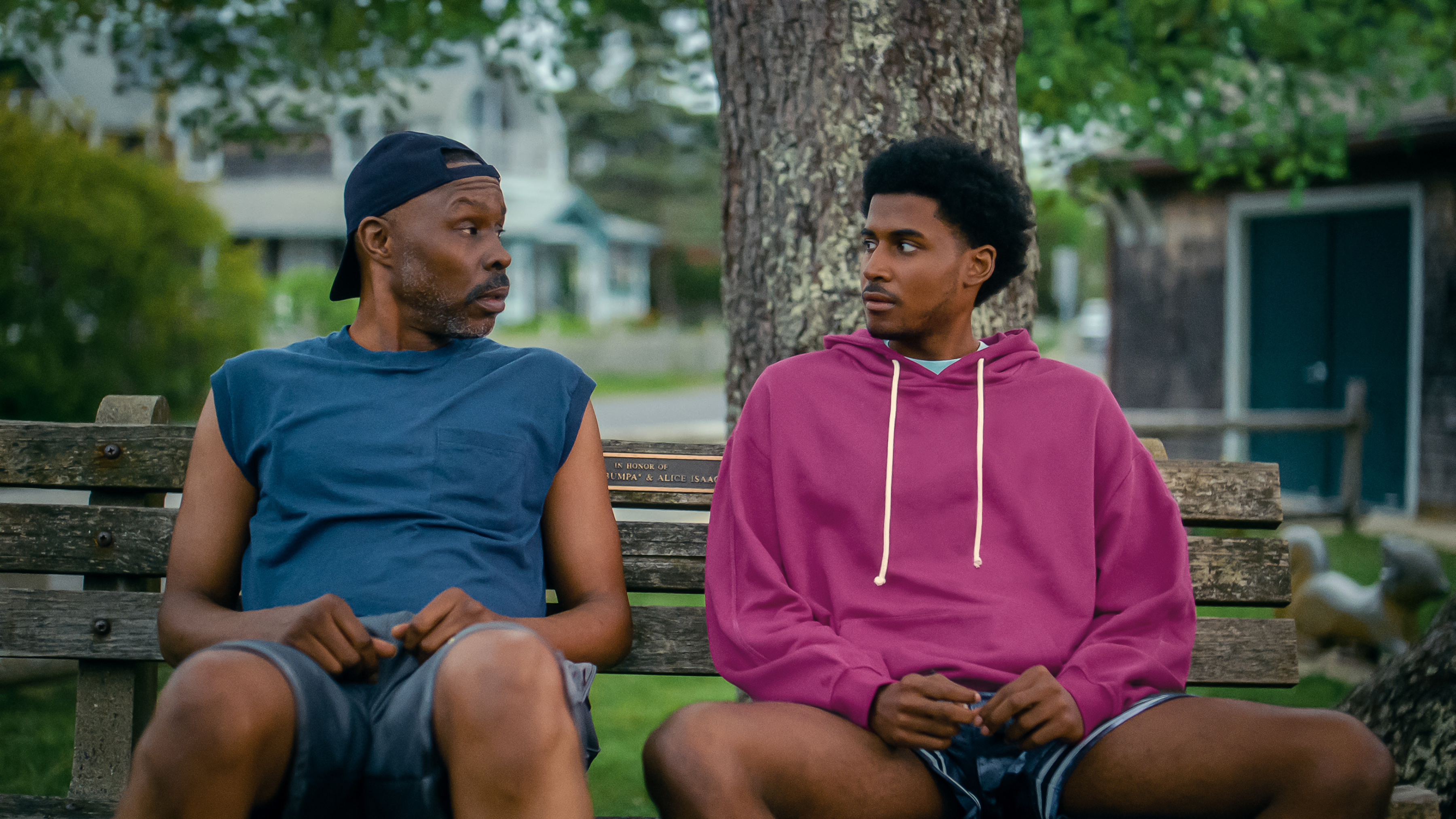 Wood Harris as Eric Edwards and Michael Cooper Jr. as Justin Edwards sitting on a bench outside in the tv show forever
