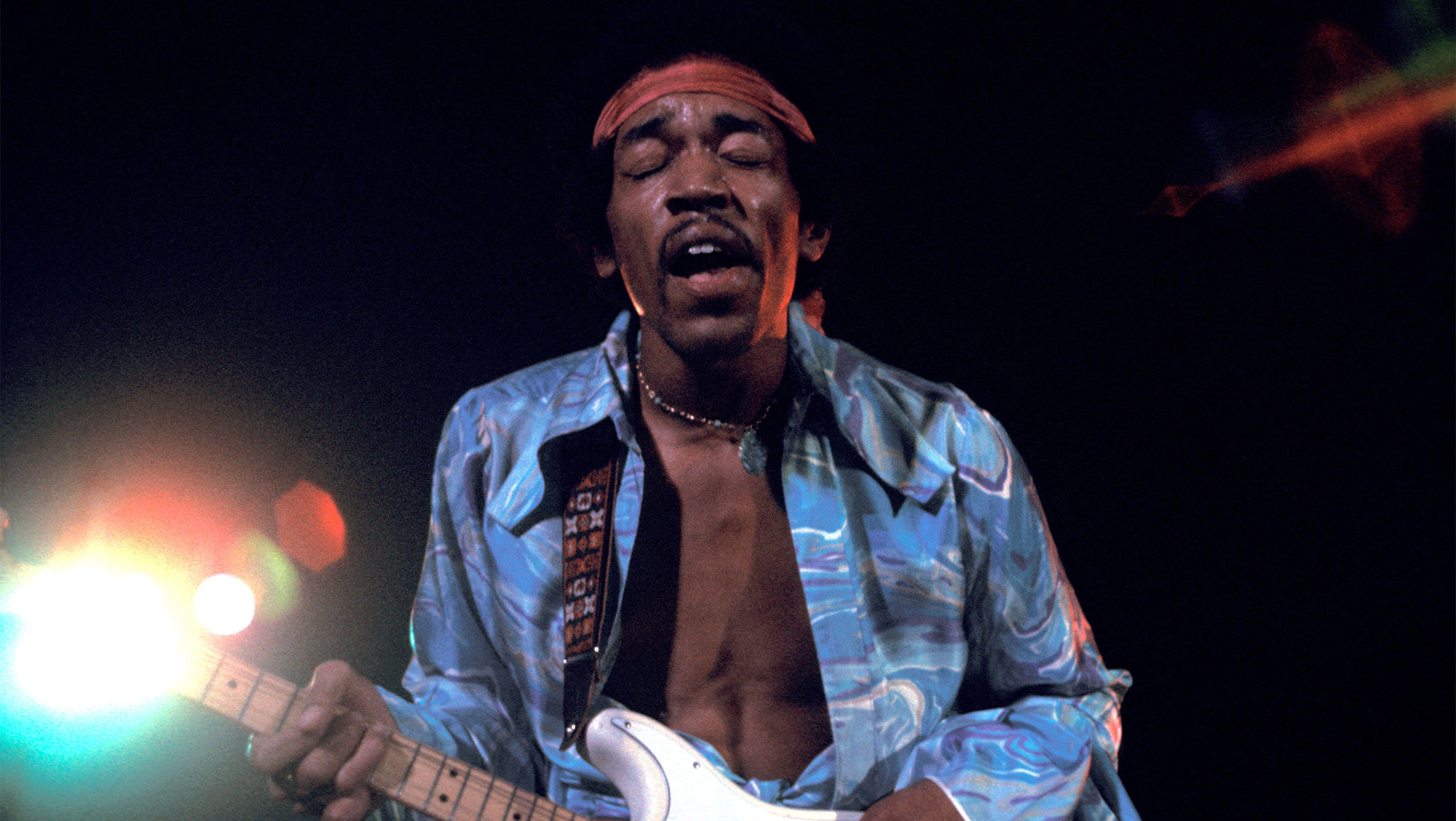 JIMI HENDRIX performs live at a street concert in Harlem. 