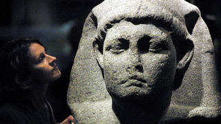 Sally-Ann Ashton admires one of the statues of Cleopatra at the launch of a new exhibition at The British Museum in London 10 April 2001.
