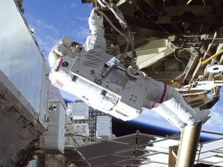 During the STS-129 mission's first spacewalk in November 2009, astronauts Mike Foreman installed a spare S-band antenna structural assembly on the station's truss.
