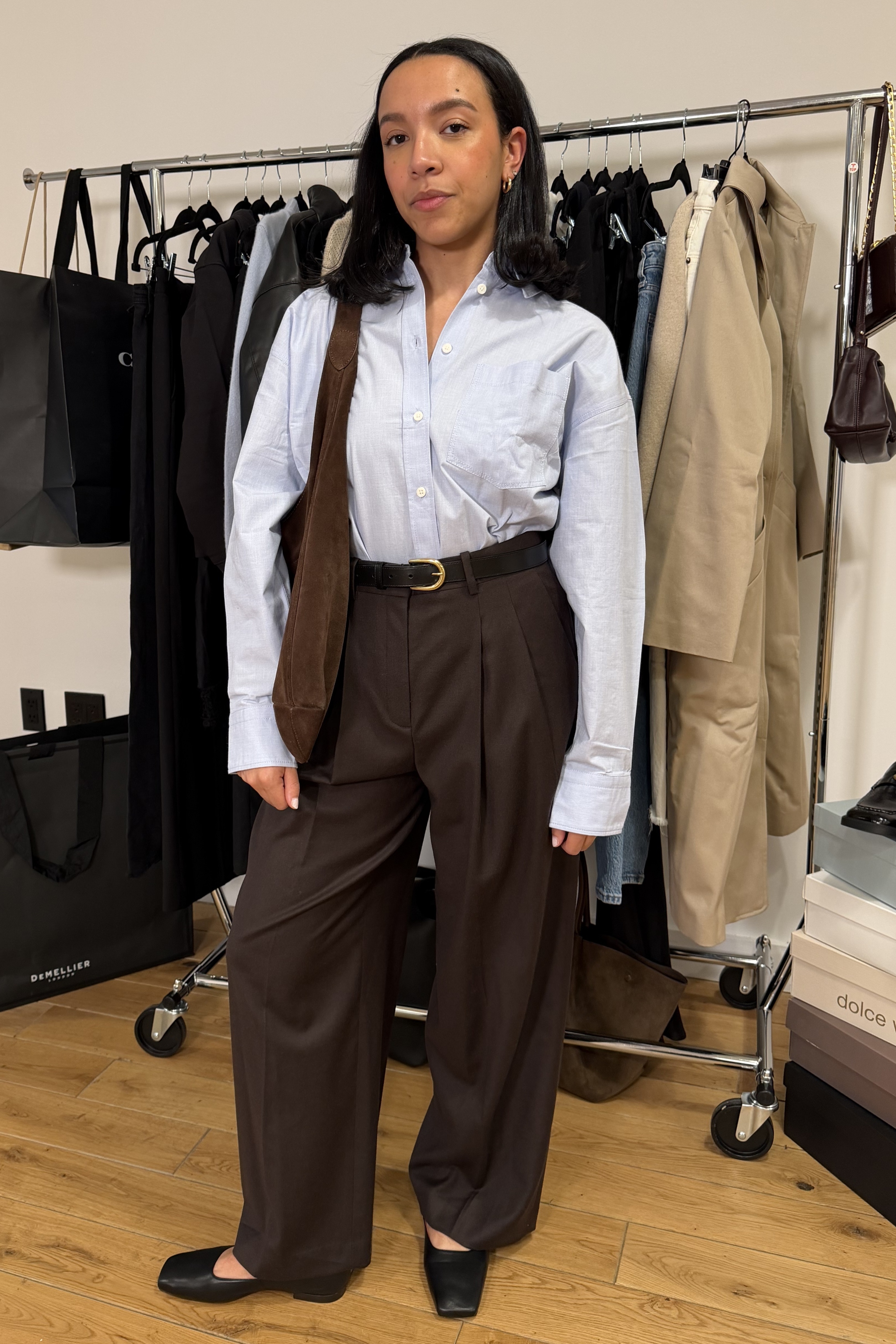 Lauren Tappan wearing a button-down, trousers, and high-vamp flats.