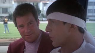 William Shatner smiles while talking to Leonard Nimoy in Star Trek IV: The Voyage Home.