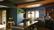 Moody dark kitchen with island and wooden accents
