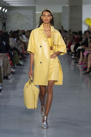 Model on Max Mara S/S 2022 womenswear runway wearing yellow