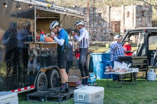 Cyclists wait at a food truck during an event