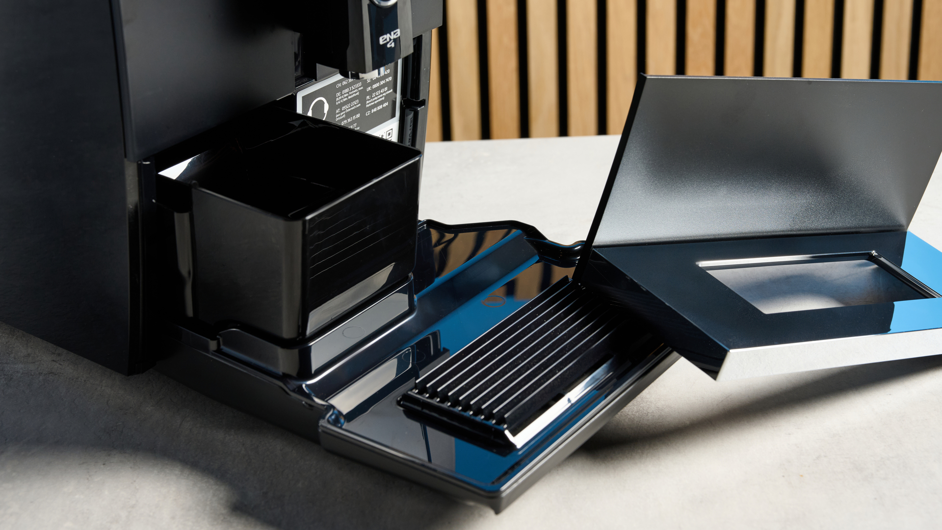 the jura ena 4 automatic coffee machine in piano black with a faceted water tank and bright screen