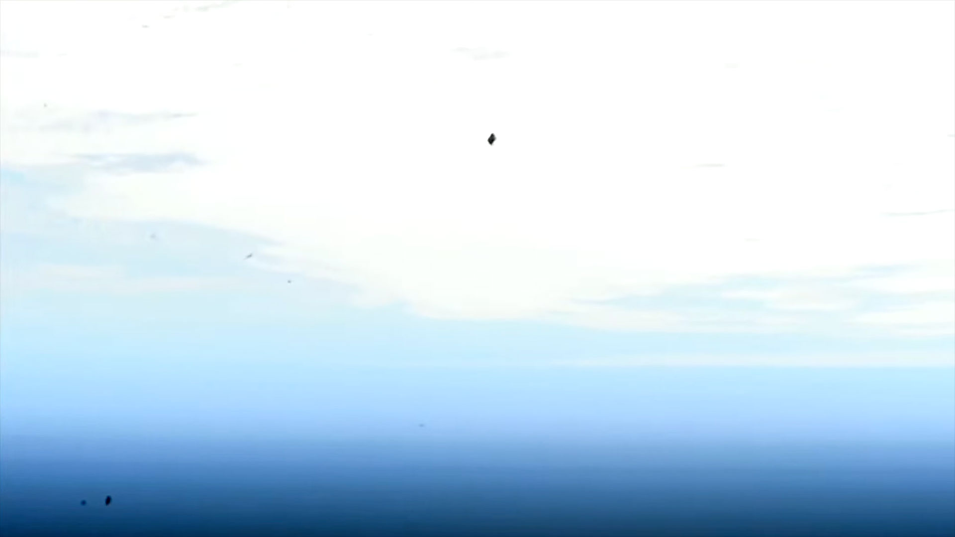 a distant spacecraft is scene against the backdrop of a blue and white planet