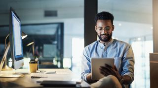 man using a tablet in an office