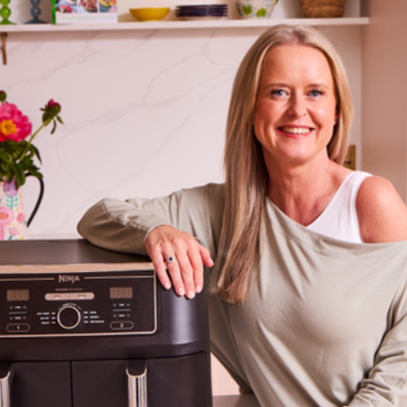 Headshot of Clare Andrews with air fryer