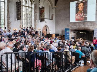 Dartington Hall, Totnes, Devon, UK. Festival goers in the packed Great Hall at the Ways With Words literary festival